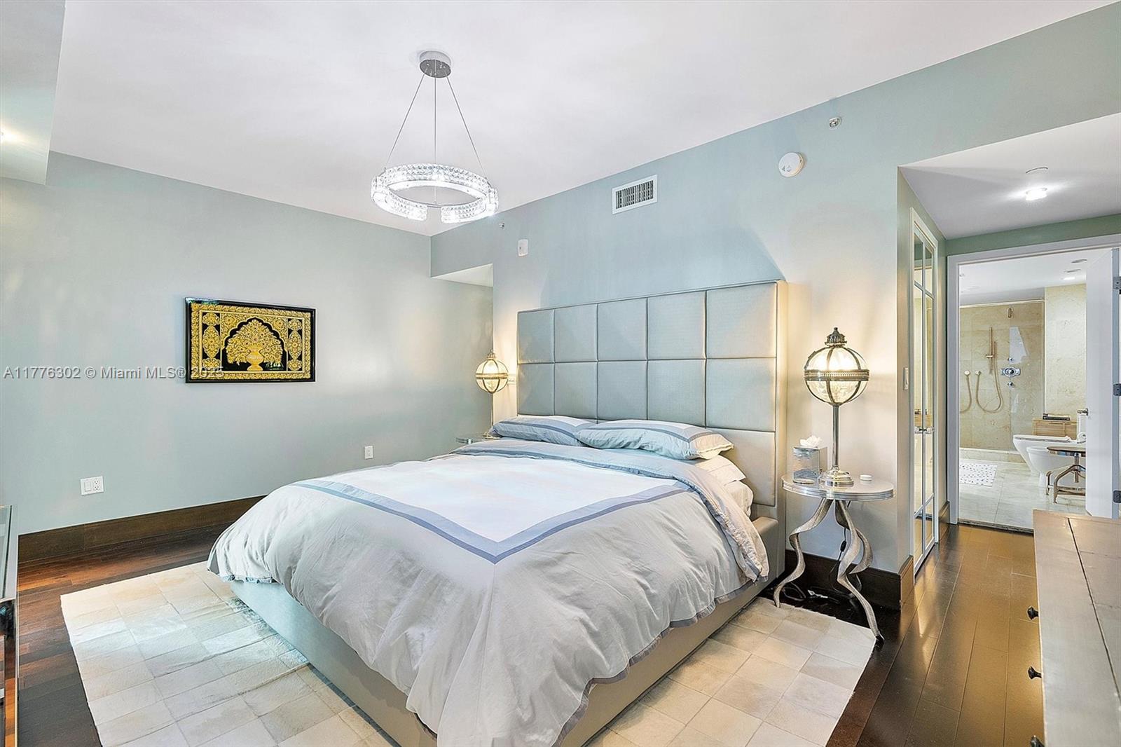 6000 Collins Avenue, Unit 326 Miami Beach, FL 33140 - Photo 28 of 45 a bedroom with a bed and a chandelier