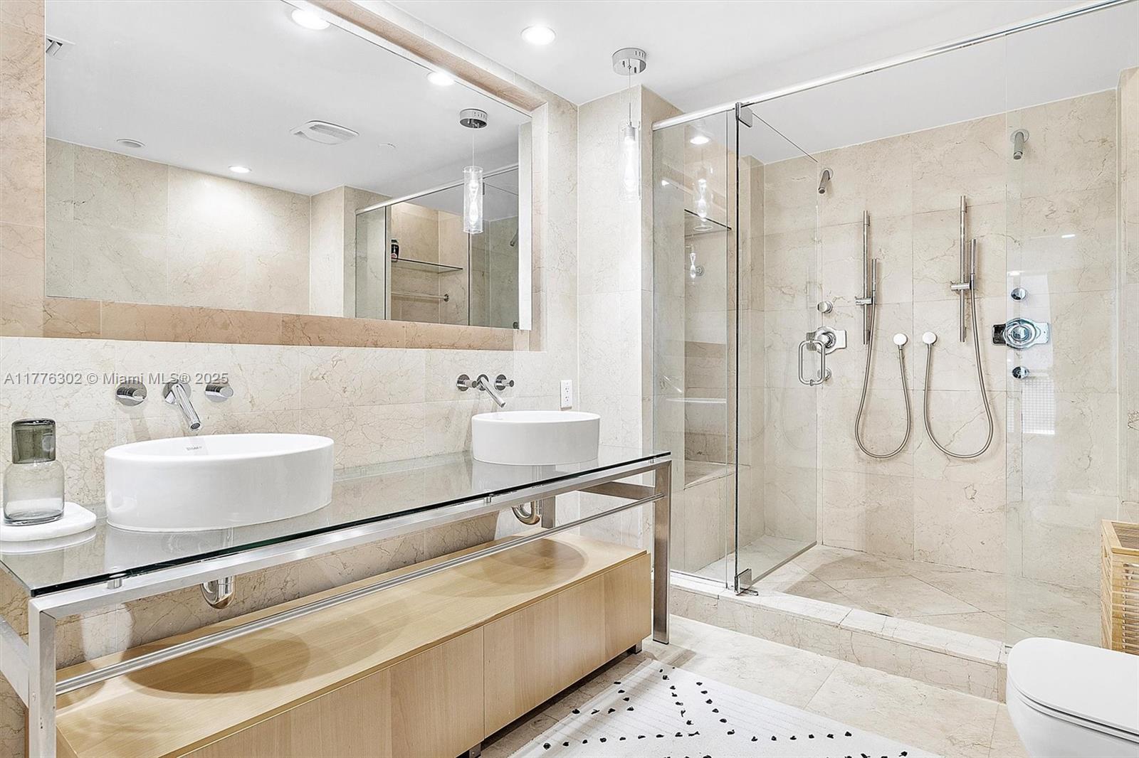 6000 Collins Avenue, Unit 326 Miami Beach, FL 33140 - Photo 30 of 45 a bathroom with a bathtub shower sink and toilet