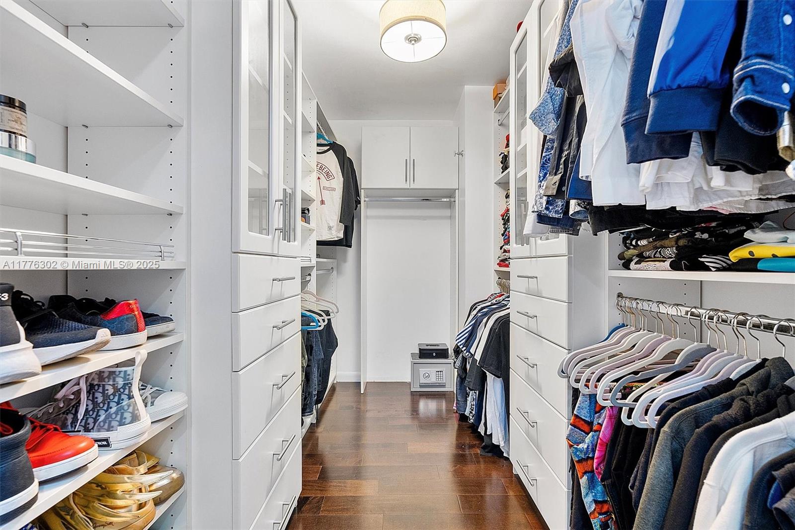 6000 Collins Avenue, Unit 326 Miami Beach, FL 33140 - Photo 31 of 45 a view of walk in closet with clothes and shoes