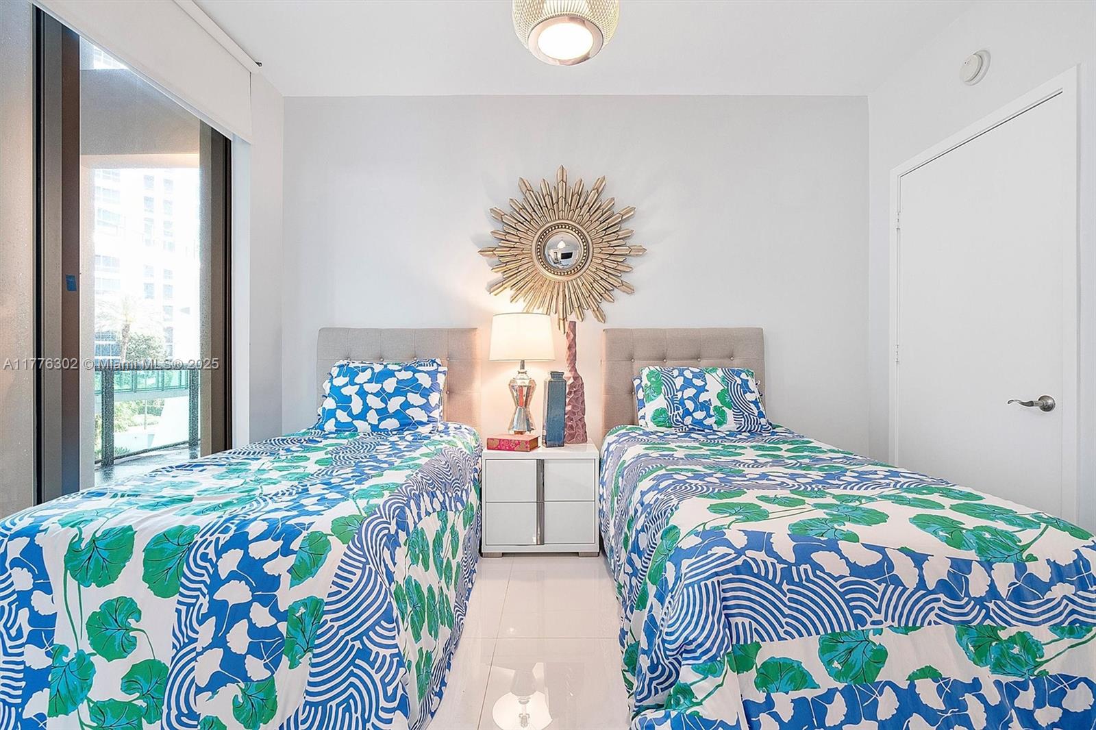 6000 Collins Avenue, Unit 326 Miami Beach, FL 33140 - Photo 33 of 45 a bedroom with two beds and a table