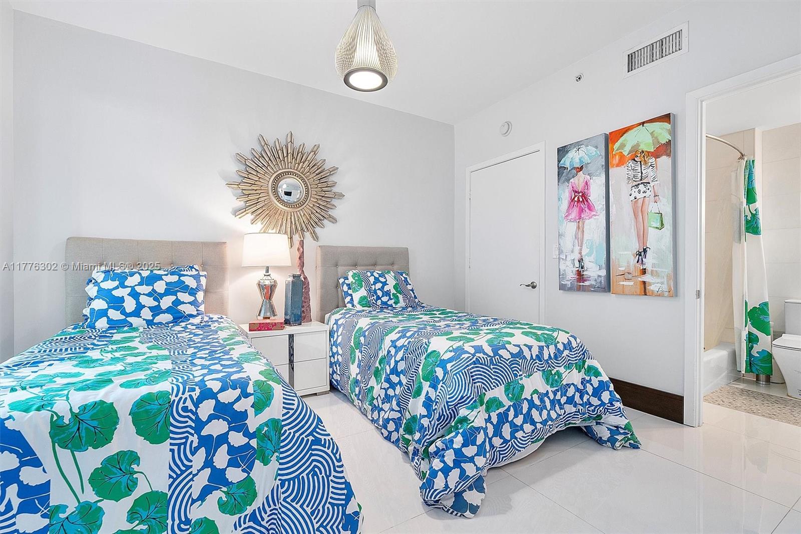 6000 Collins Avenue, Unit 326 Miami Beach, FL 33140 - Photo 34 of 45 a bedroom with two beds and a painting on the wall