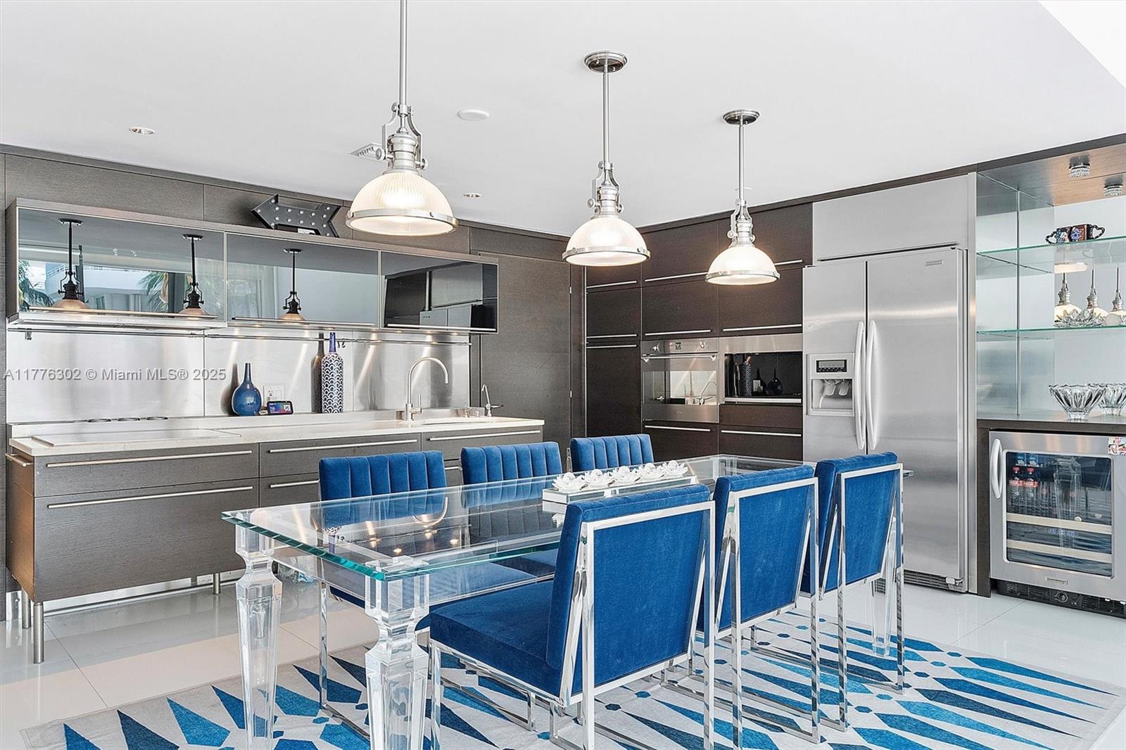 6000 Collins Avenue, Unit 326 Miami Beach, FL 33140 - Photo 5 of 45 a kitchen with stainless steel appliances granite countertop a stove a sink dishwasher a dining table and chairs with wooden floor