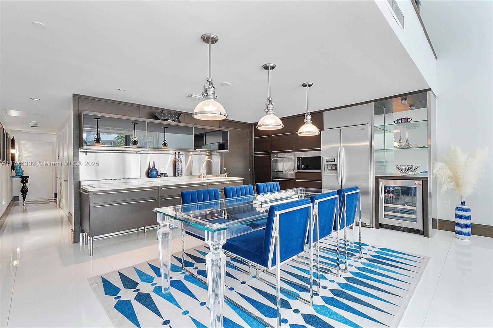 6000 Collins Avenue, Unit 326 Miami Beach, FL 33140 - Photo 7 of 45 a kitchen with granite countertop lots of counter top space and stainless steel appliances