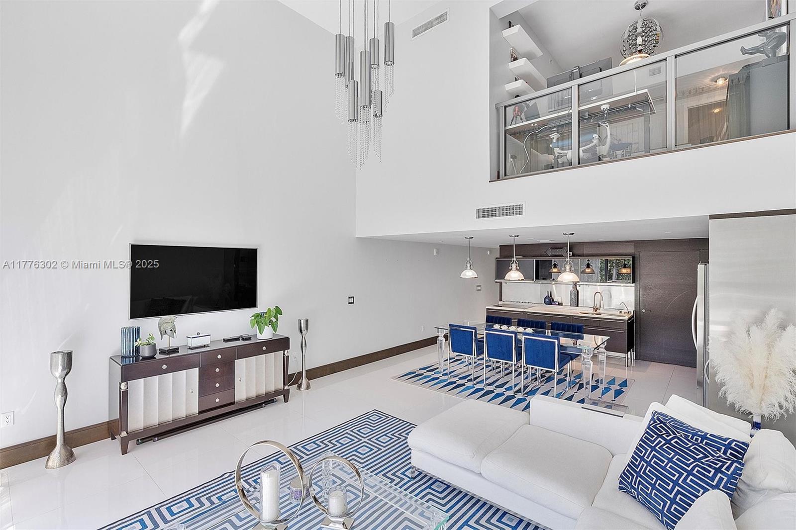 6000 Collins Avenue, Unit 326 Miami Beach, FL 33140 - Photo 10 of 45 a living room with furniture and flat screen tv