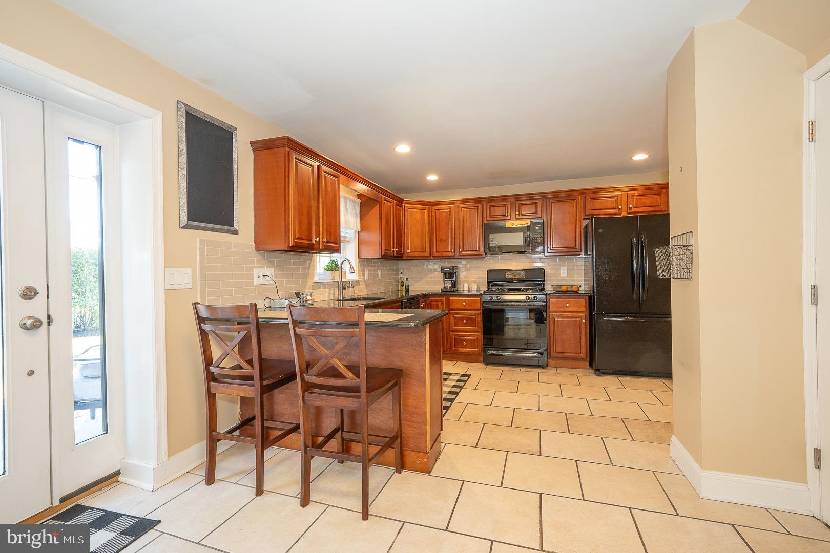 226 East Springfield Road Springfield, PA 19064 - Photo 37 of 75 a kitchen with stainless steel appliances granite countertop a refrigerator and a stove top oven