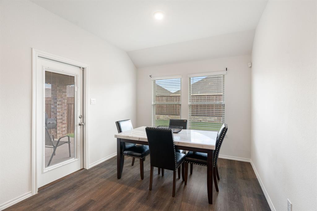 3413 Perman Drive Forney, TX 75126 - Photo 11 of 33 a view of a dining room with furniture and wooden floor