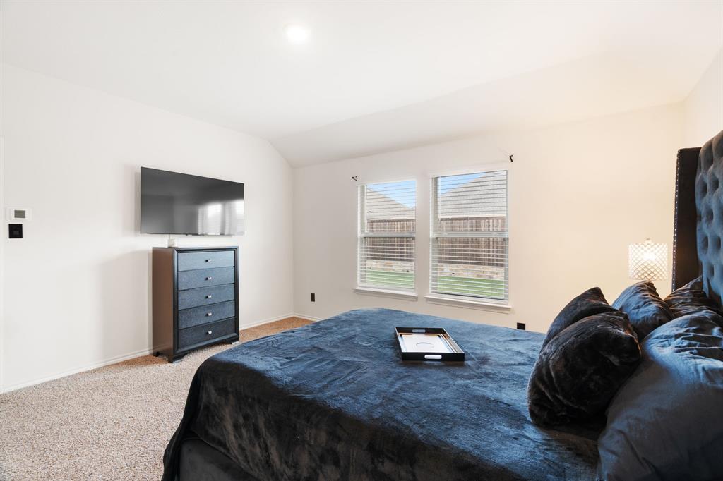 3413 Perman Drive Forney, TX 75126 - Photo 16 of 33 a bedroom with a bed and a television
