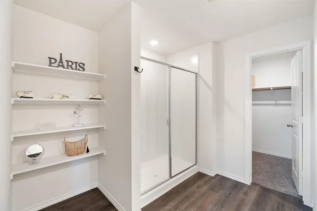 a bedroom with a bed and a television