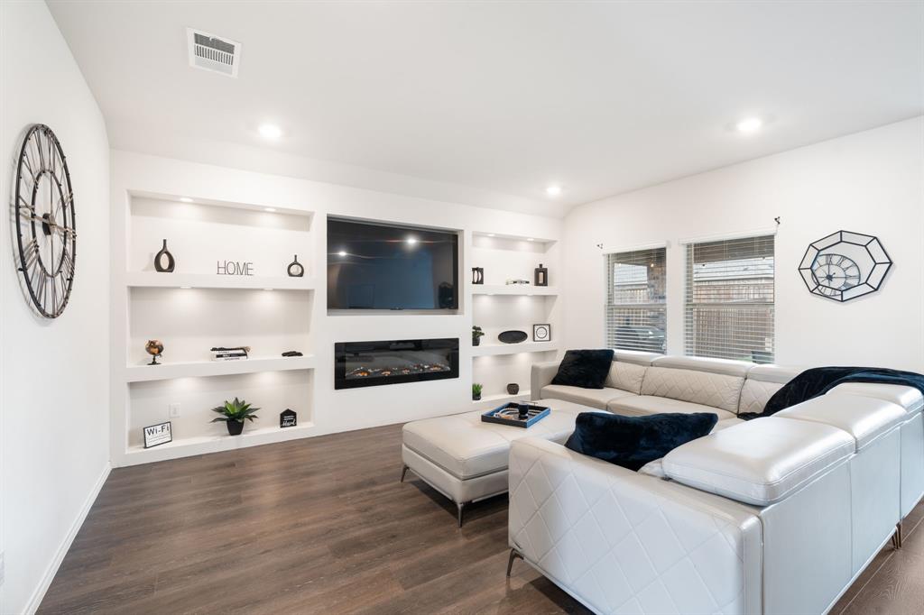a living room with fireplace furniture and a flat screen tv