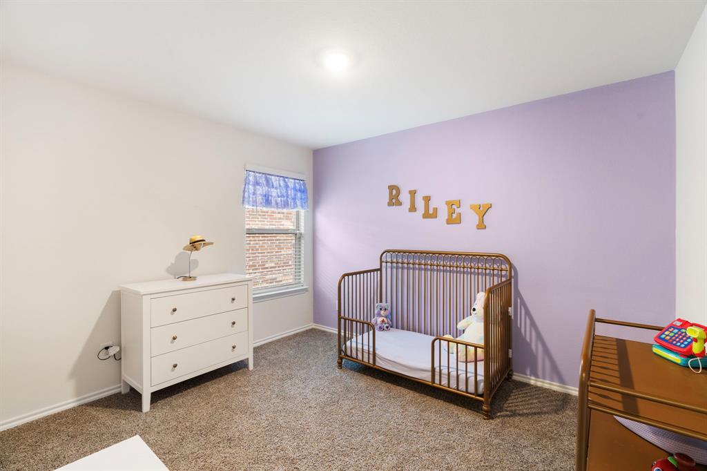 3413 Perman Drive Forney, TX 75126 - Photo 20 of 33 a bedroom with a bed and a dresser in it