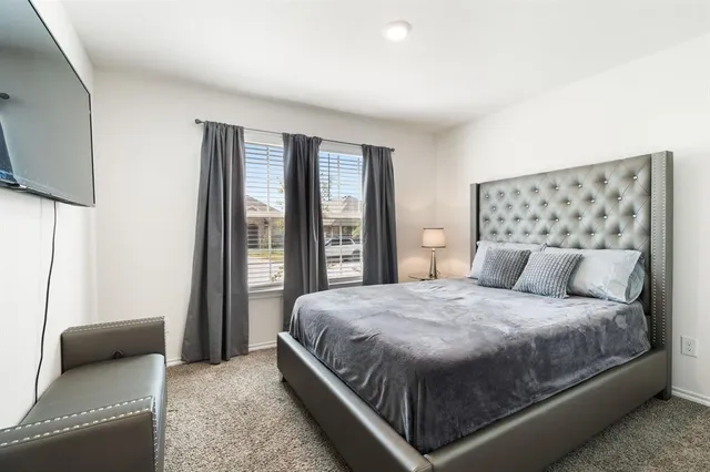 a bedroom with a bed and a dresser in it