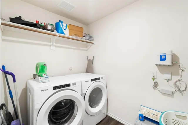 a bedroom with a large bed and a flat tv screen on dresser
