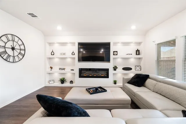 a living room with fireplace furniture and a flat screen tv