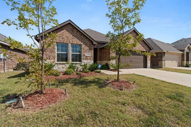 a front view of a house with yard