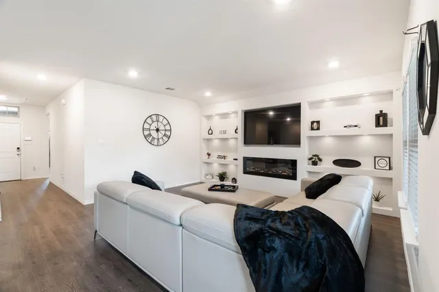 a living room with furniture and view of kitchen