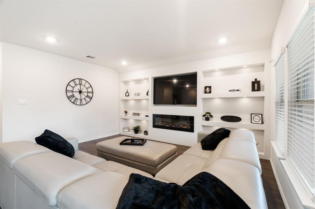 3413 Perman Drive Forney, TX 75126 - Photo 5 of 33 a living room with a white couch and a flat screen tv