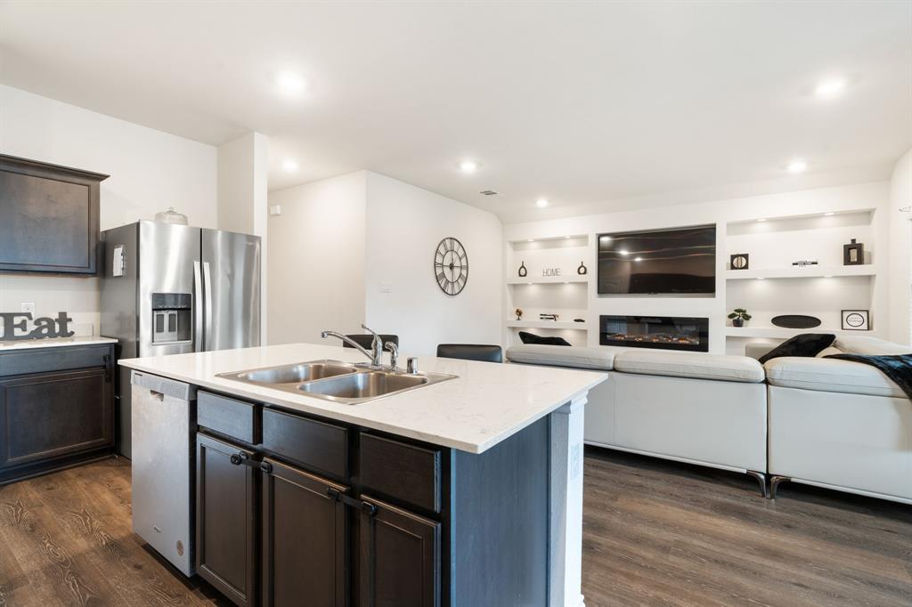 3413 Perman Drive Forney, TX 75126 - Photo 33 of 33 a kitchen with stainless steel appliances granite countertop a sink stove and refrigerator