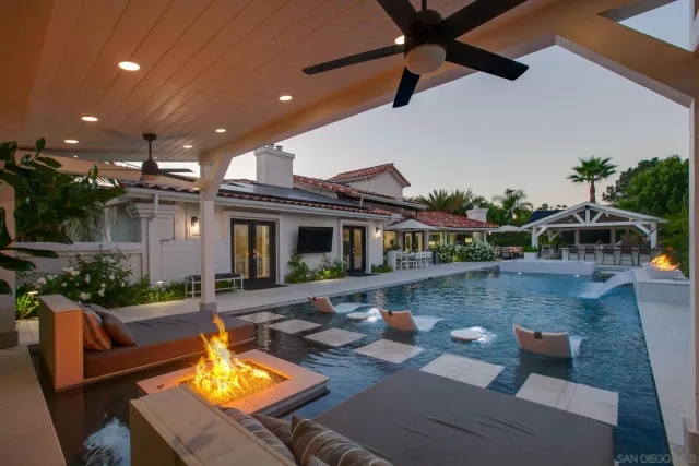 a view of a house with swimming pool and sitting area