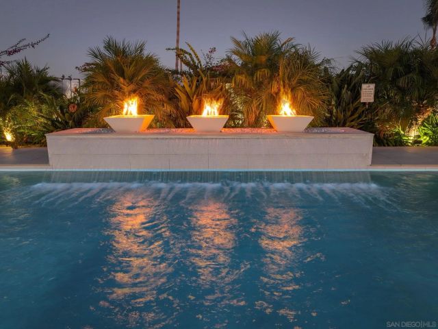 a view of swimming pool and trees in the background