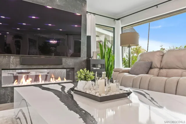 a view of a kitchen with kitchen island stainless steel appliances wooden floor dining table and chairs
