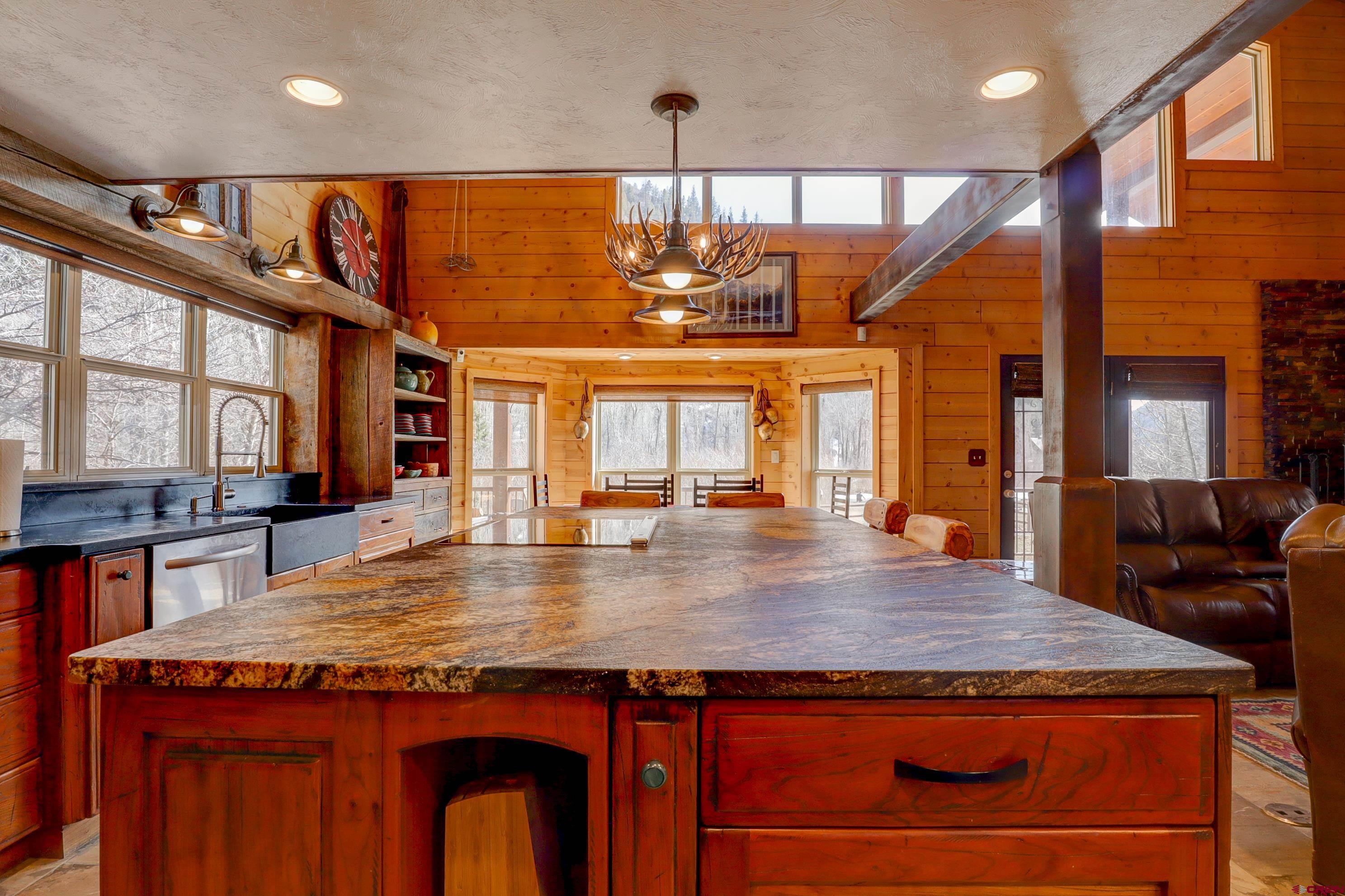 25112 Road 38.1 Dolores, CO 81323 - Photo 11 of 35 an open kitchen with a sink and large wooden cabinets