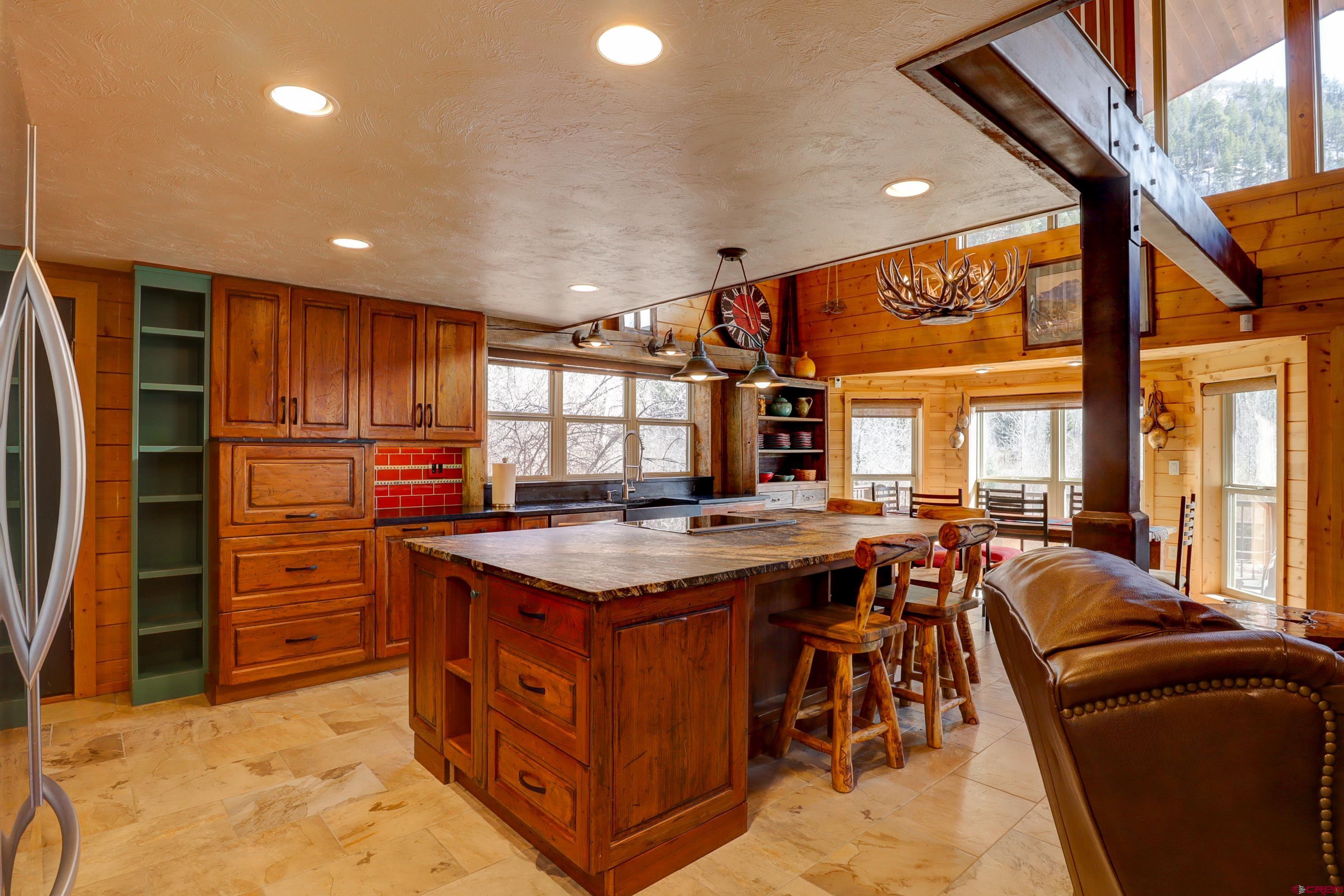 25112 Road 38.1 Dolores, CO 81323 - Photo 12 of 35 a kitchen with a stove a refrigerator and wooden cabinets