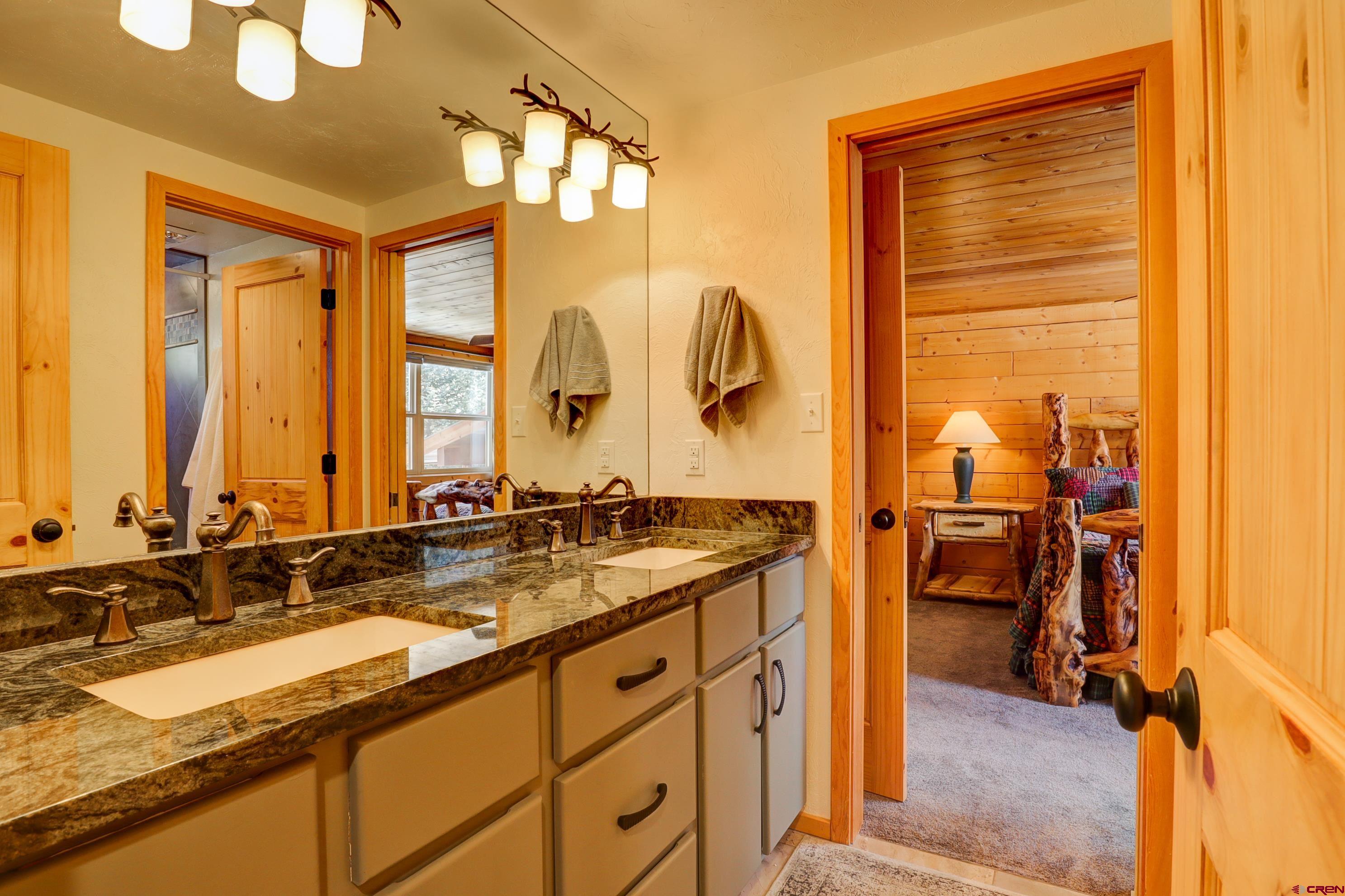 25112 Road 38.1 Dolores, CO 81323 - Photo 15 of 35 a bathroom with a granite countertop sink and a mirror