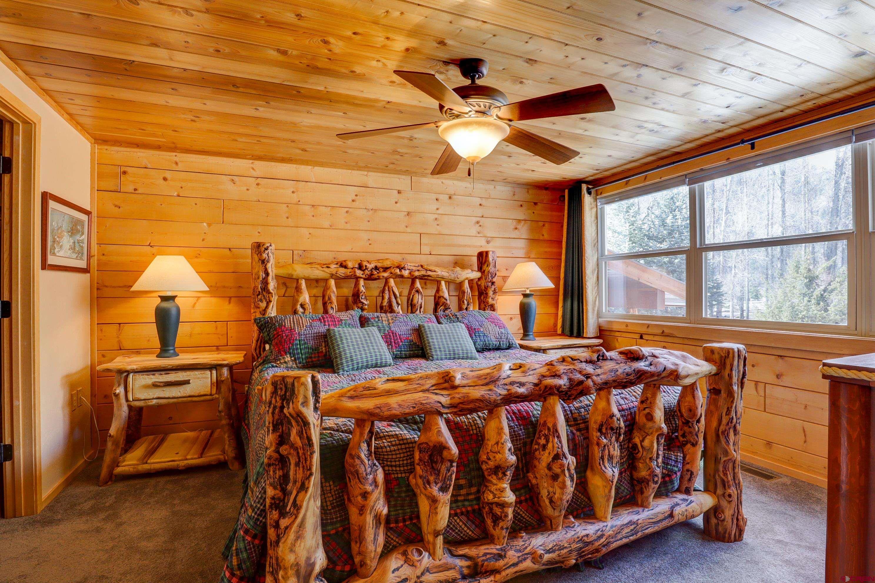 25112 Road 38.1 Dolores, CO 81323 - Photo 17 of 35 a bedroom with a bed and a chandelier