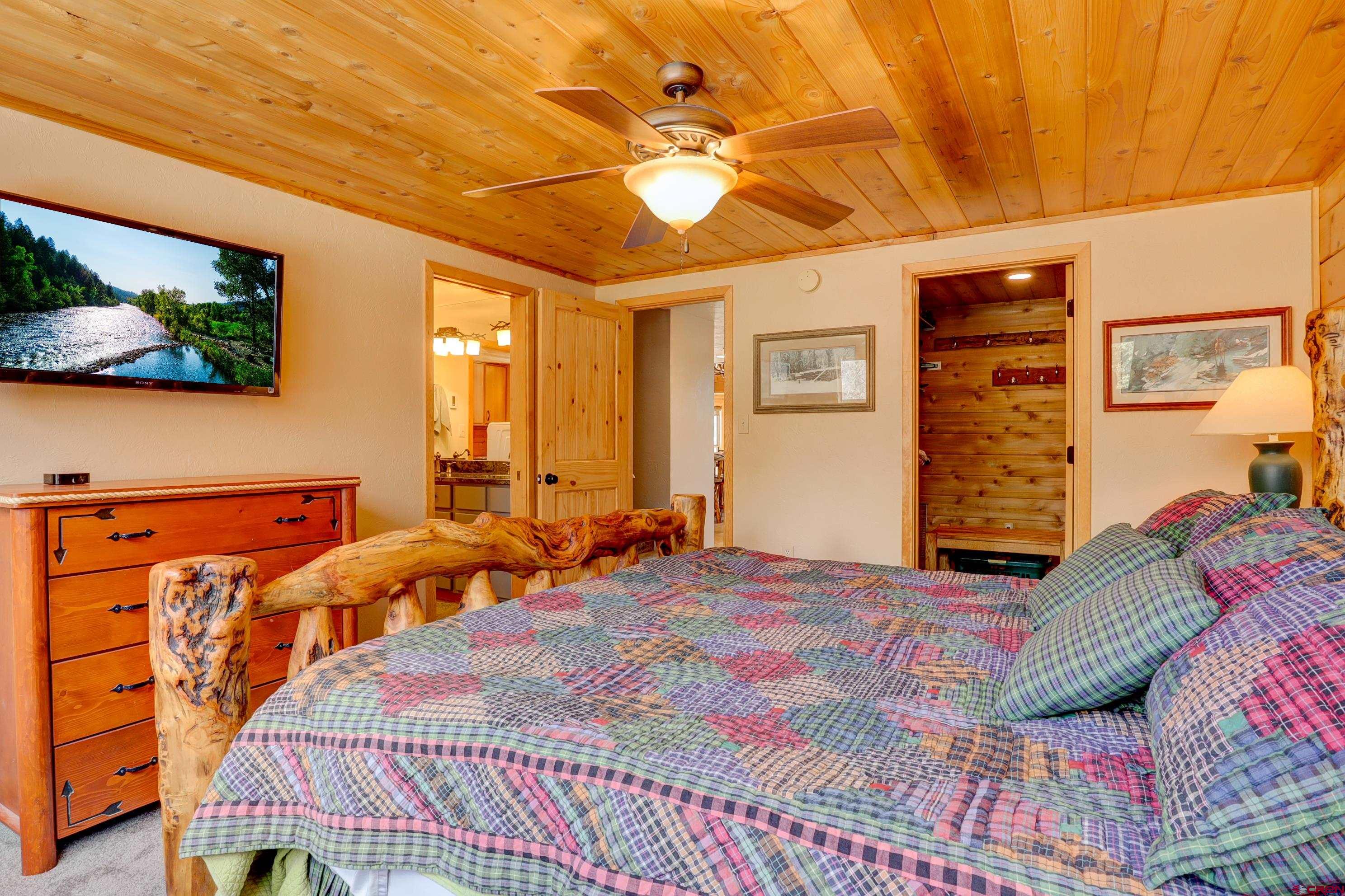 25112 Road 38.1 Dolores, CO 81323 - Photo 18 of 35 a bedroom with a bed and a walk in closet