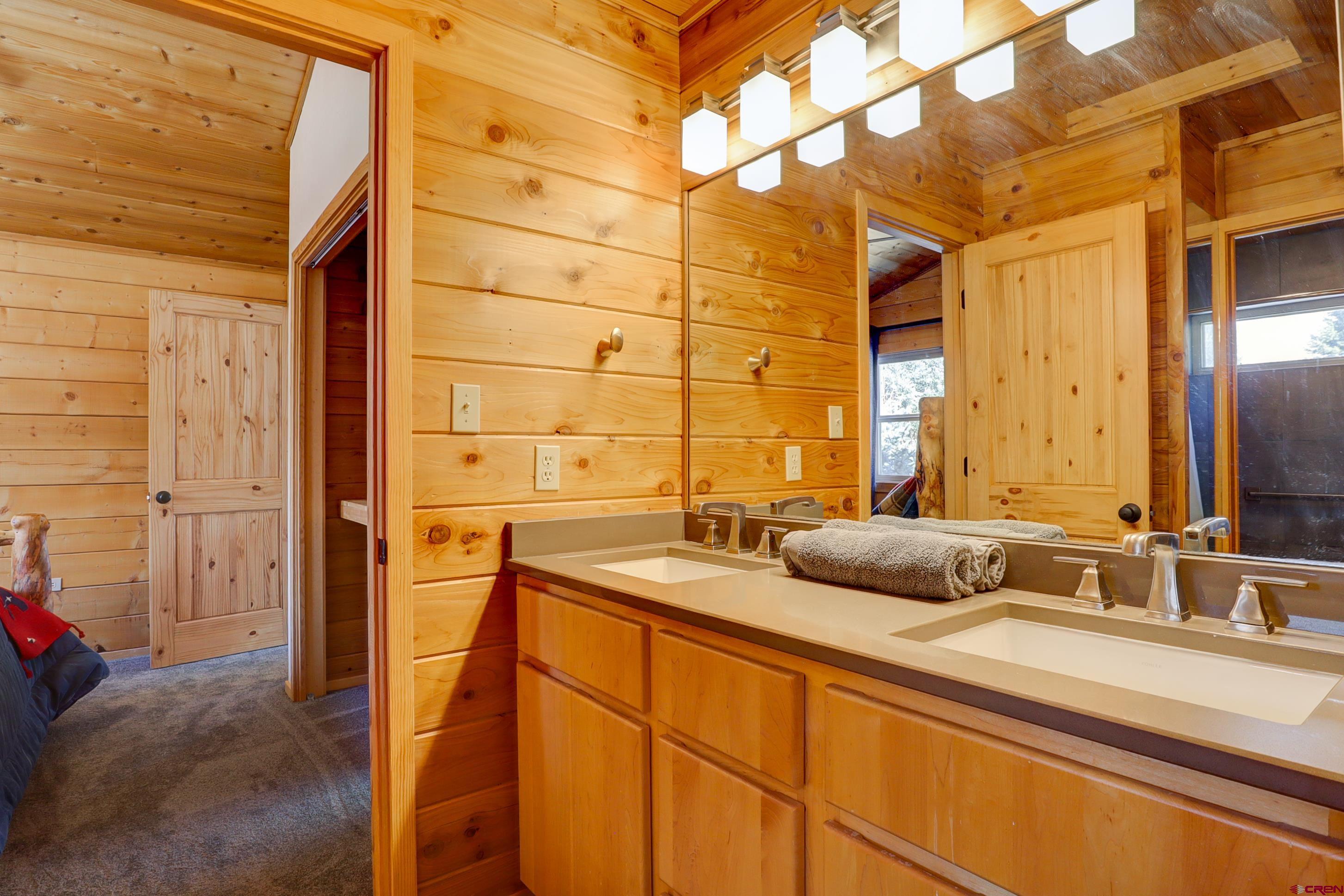 25112 Road 38.1 Dolores, CO 81323 - Photo 24 of 35 a bathroom with a double vanity sink and a mirror