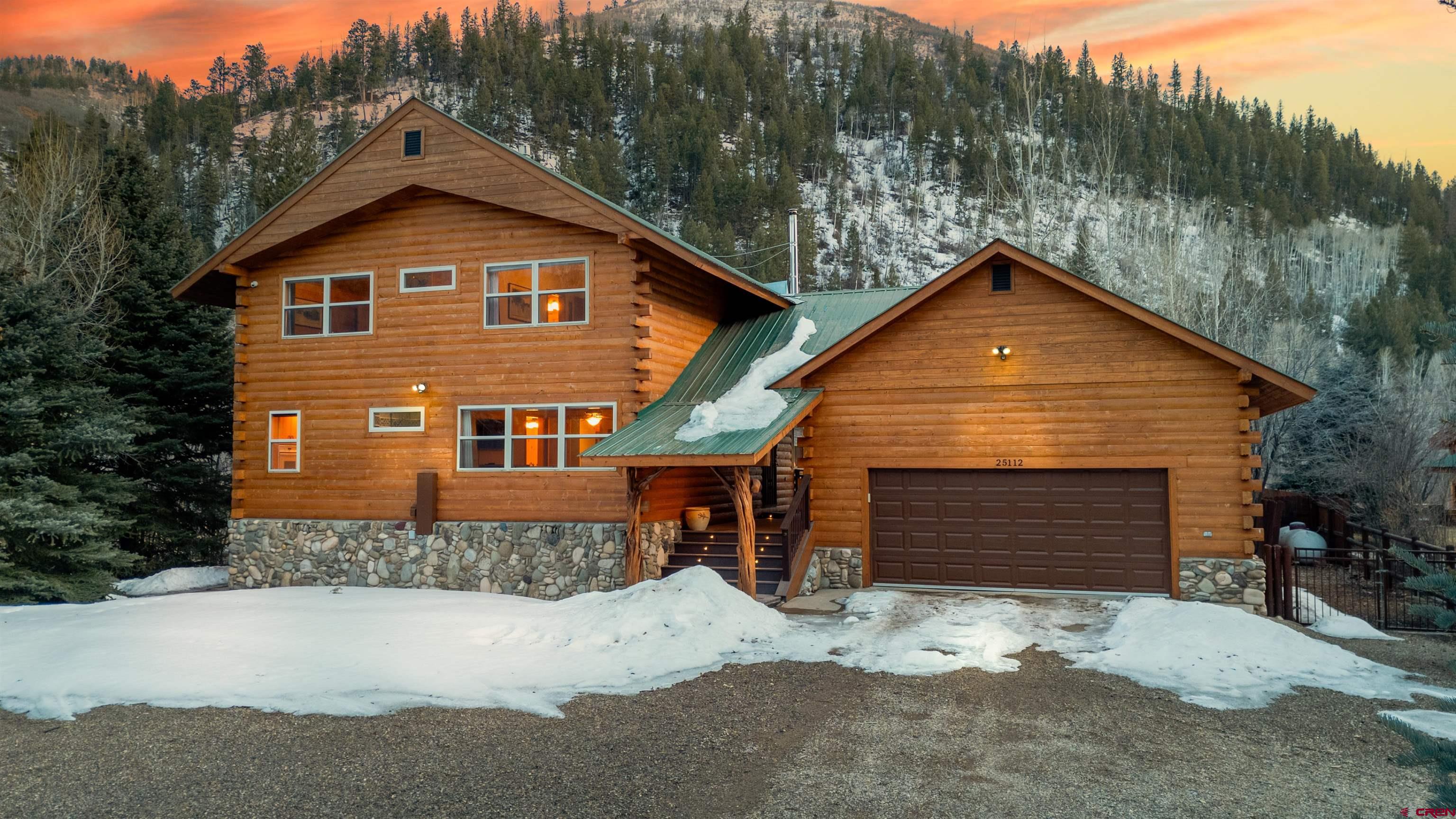25112 Road 38.1 Dolores, CO 81323 - Photo 4 of 35 a front view of a house with a yard and garage
