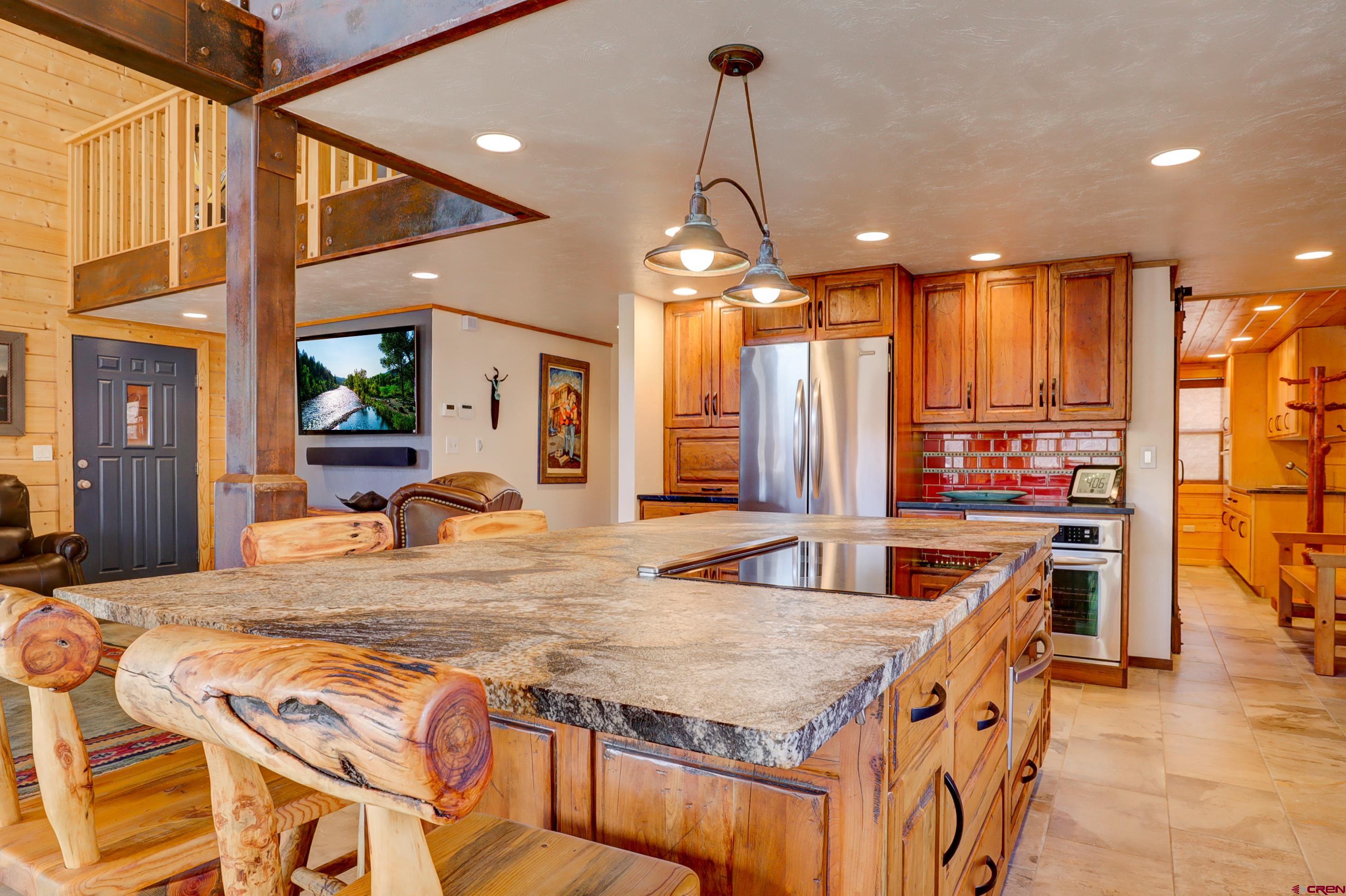 25112 Road 38.1 Dolores, CO 81323 - Photo 8 of 35 a kitchen with stainless steel appliances granite countertop a sink a stove and a wooden floors