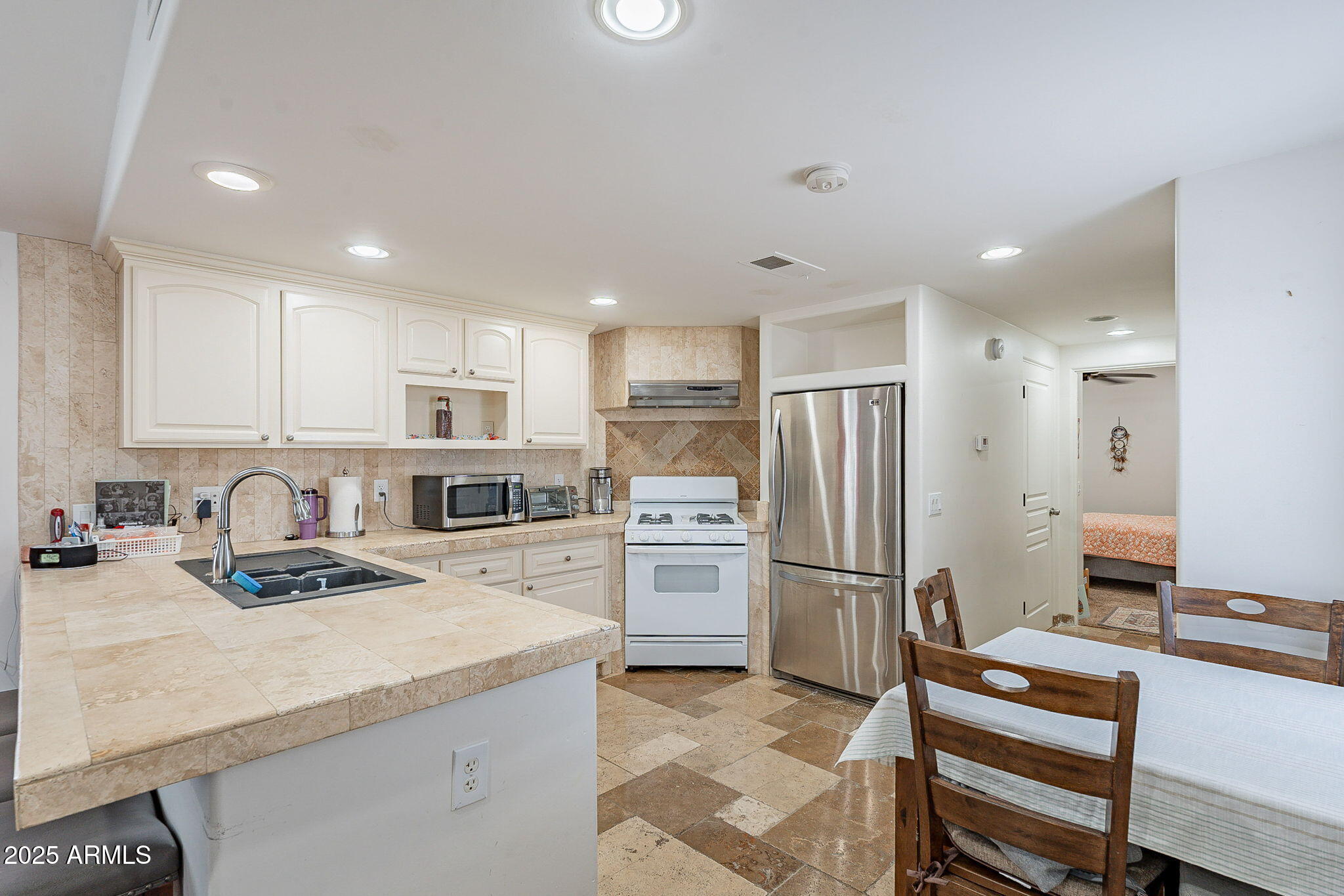 15606 South Gilbert Road, Unit 63 Chandler, AZ 85225 - Photo 7 of 21 a kitchen with refrigerator cabinets and wooden floor