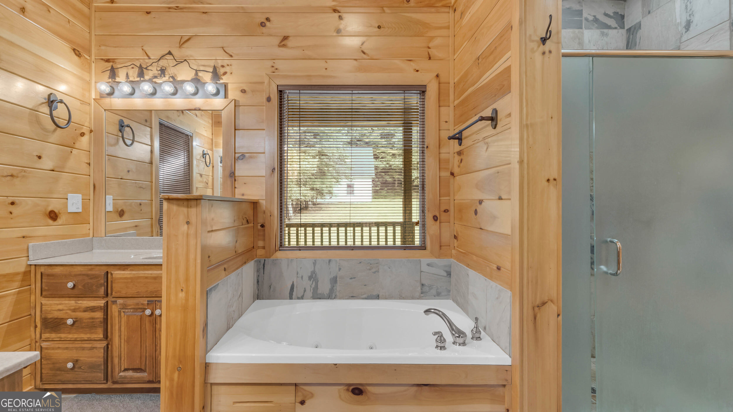 661 North Toccoa River Road Mineral Bluff, GA 30559 - Photo 23 of 68 a bathroom with a bathtub and a shower
