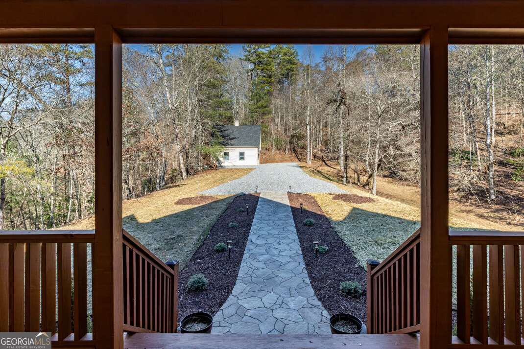 661 North Toccoa River Road Mineral Bluff, GA 30559 - Photo 7 of 68 a view of a balcony with lake and wooden floor