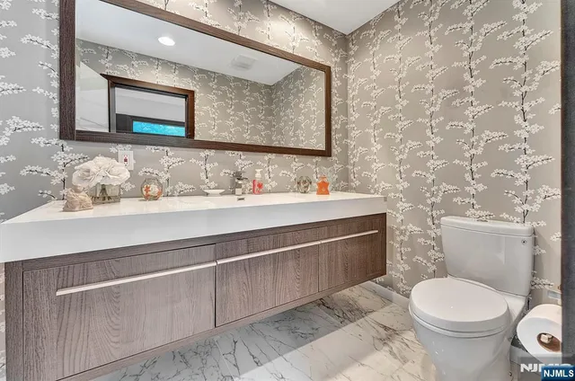 a living room with furniture and a book shelf