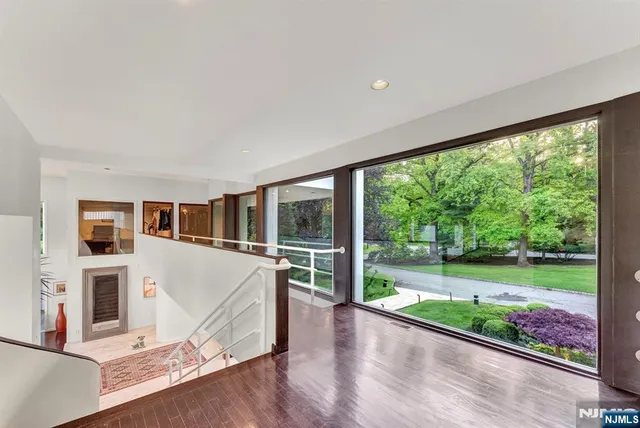 a bedroom with a bed a lamp and a large window