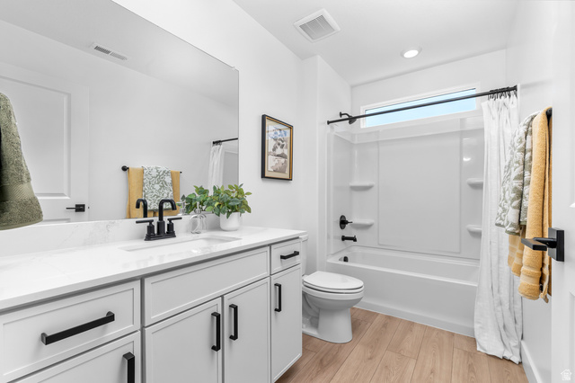 1352 West 2350 South, Unit 18 Perry, UT 84302 - Photo 19 of 26 Bathroom featuring a white vanity with black hardware, a quartz countertop, and an undermount sink