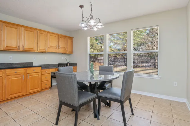 a kitchen with stainless steel appliances granite countertop a sink and a refrigerator