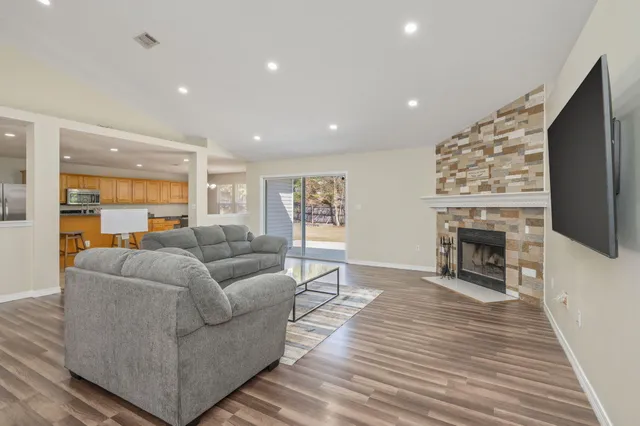 a kitchen with stainless steel appliances granite countertop a refrigerator and a stove top oven