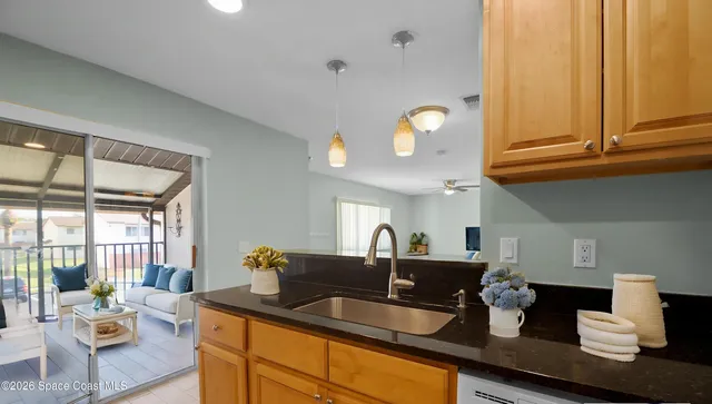 a kitchen with granite countertop a sink and cabinets
