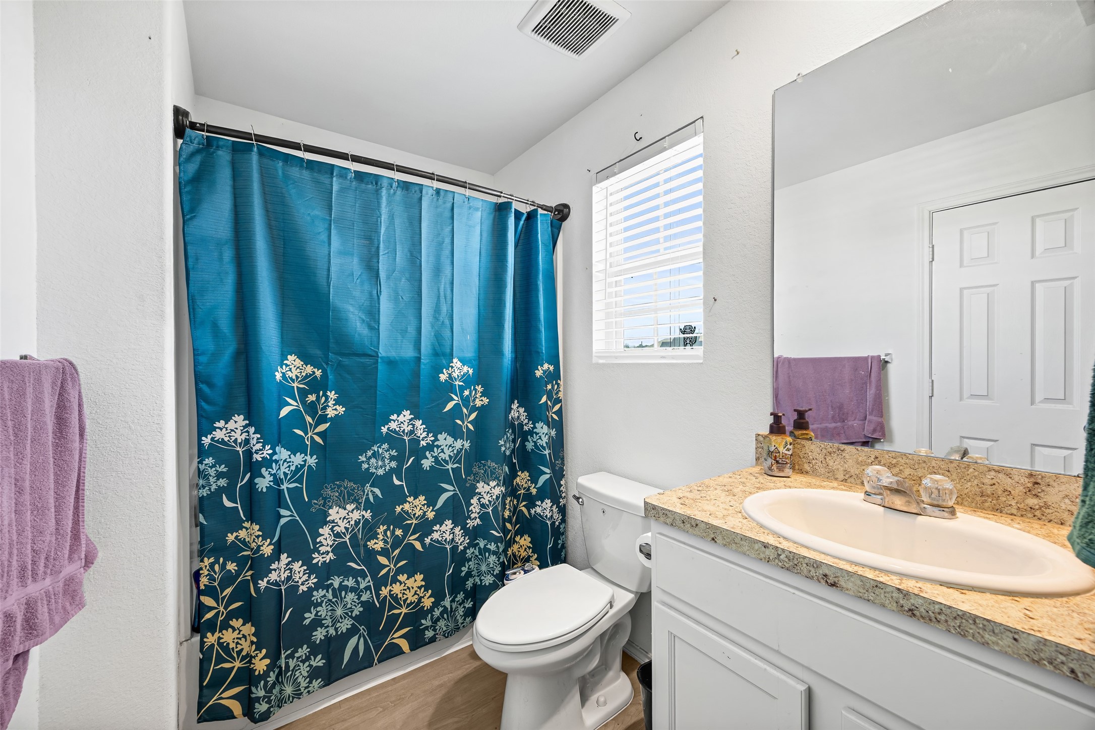 5976 Rimini Landing Lane Porter, TX 77365 - Photo 13 of 18 a bathroom with a granite countertop sink and a toilet
