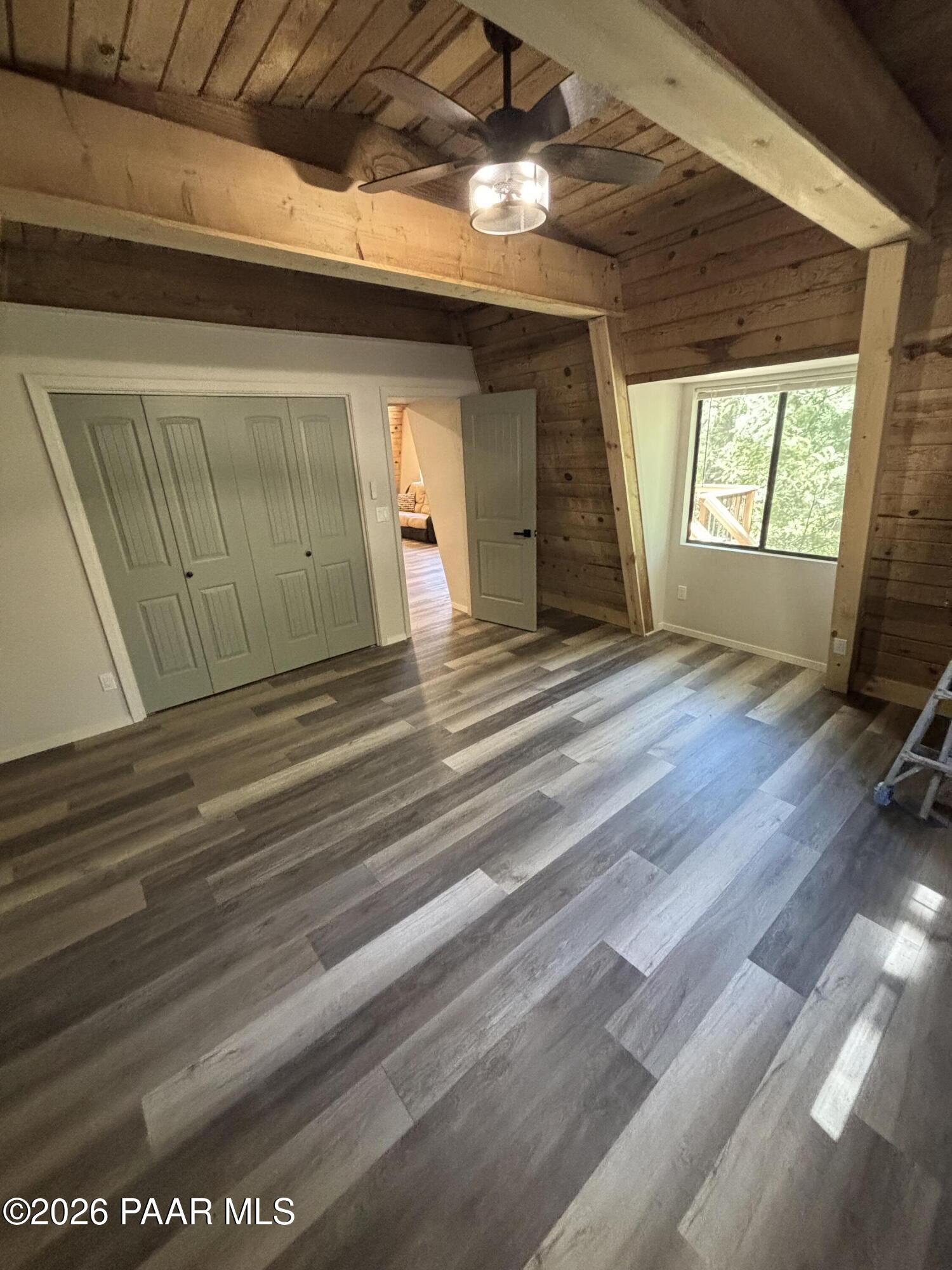 8550 South Breezy Pine Road Mayer, AZ 86333 - Photo 24 of 40 a view of a room with wooden floor and windows