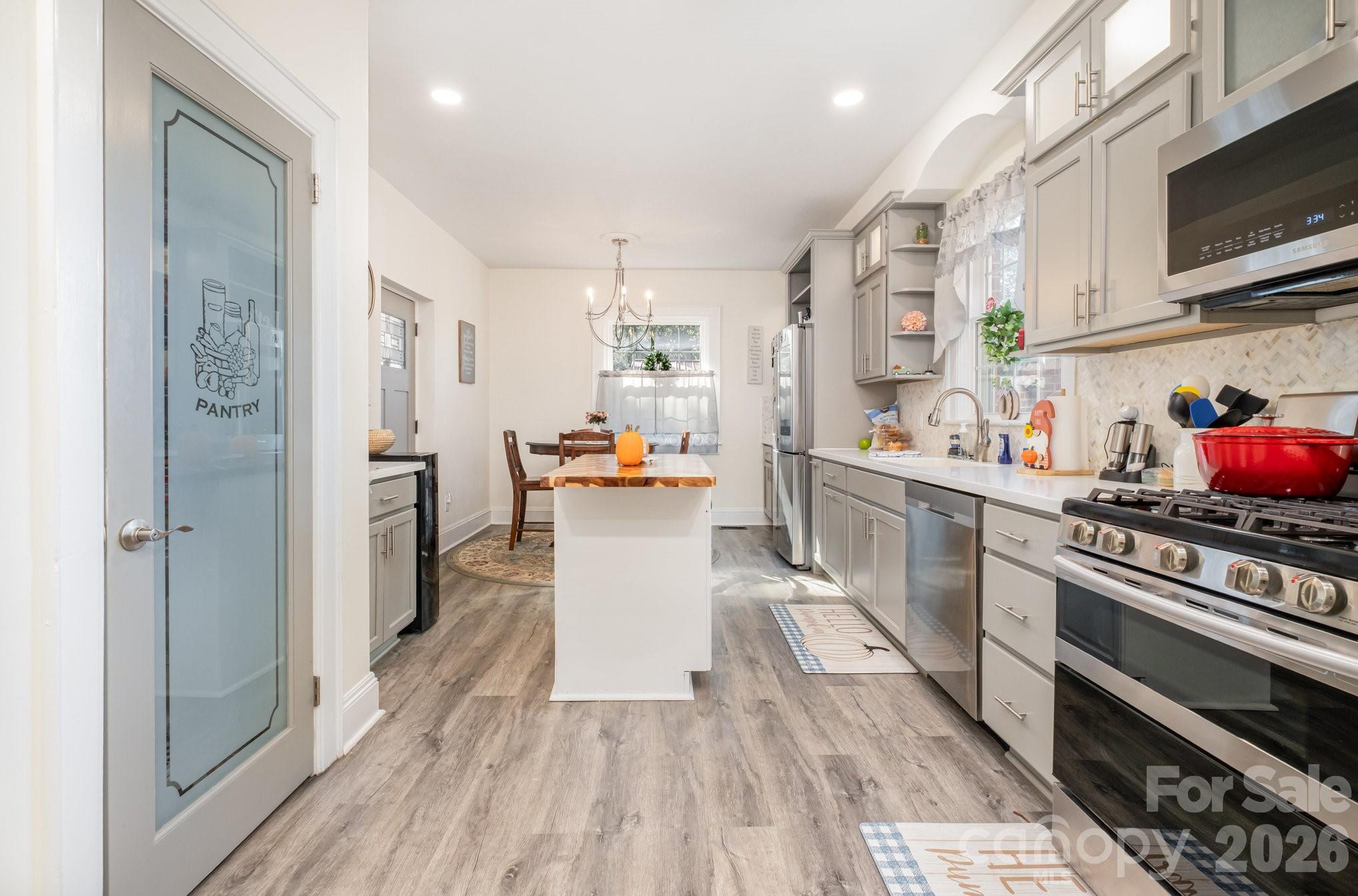 1783 Reepsville Road Lincolnton, NC 28092 - Photo 22 of 45 a kitchen with stainless steel appliances a refrigerator a stove a sink dishwasher and cabinets with wooden floor