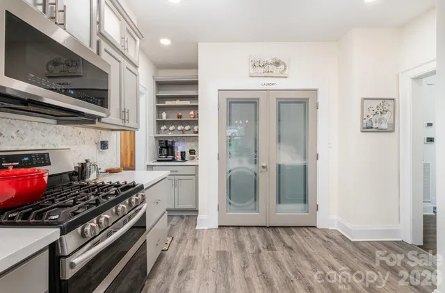 a kitchen with stainless steel appliances granite countertop a stove and a refrigerator