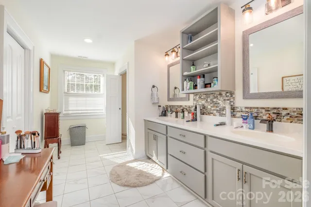 a bathroom with a sink double vanity and a mirror