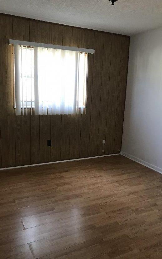 22705 Southwest 65th Terrace Boca Raton, FL 33428 - Photo 6 of 15 a view of an empty room with wooden floor and a window