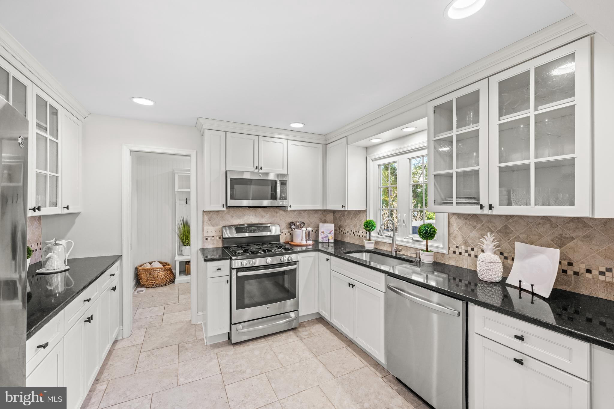 124 Deepdale Road Wayne, PA 19087 - Photo 12 of 35 a kitchen with stainless steel appliances granite countertop a sink stove and refrigerator