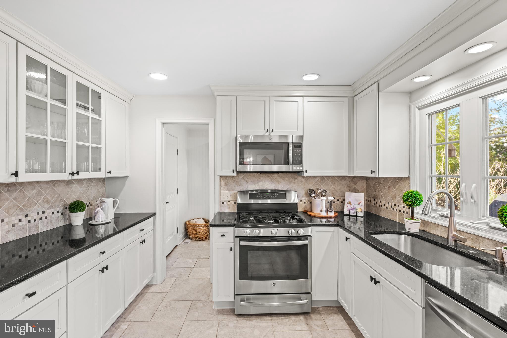 124 Deepdale Road Wayne, PA 19087 - Photo 13 of 35 a kitchen with granite countertop white cabinets and stainless steel appliances
