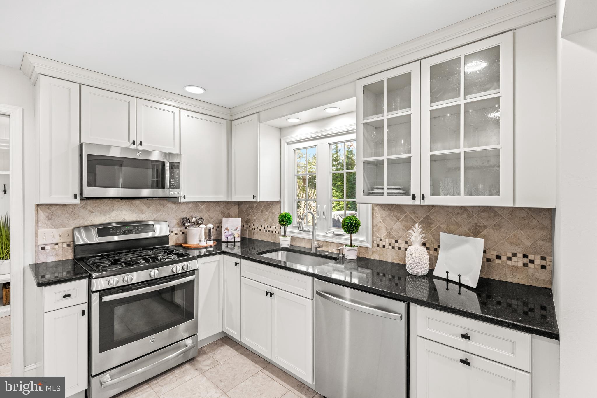 124 Deepdale Road Wayne, PA 19087 - Photo 14 of 35 a kitchen with granite countertop a sink a stove and cabinets
